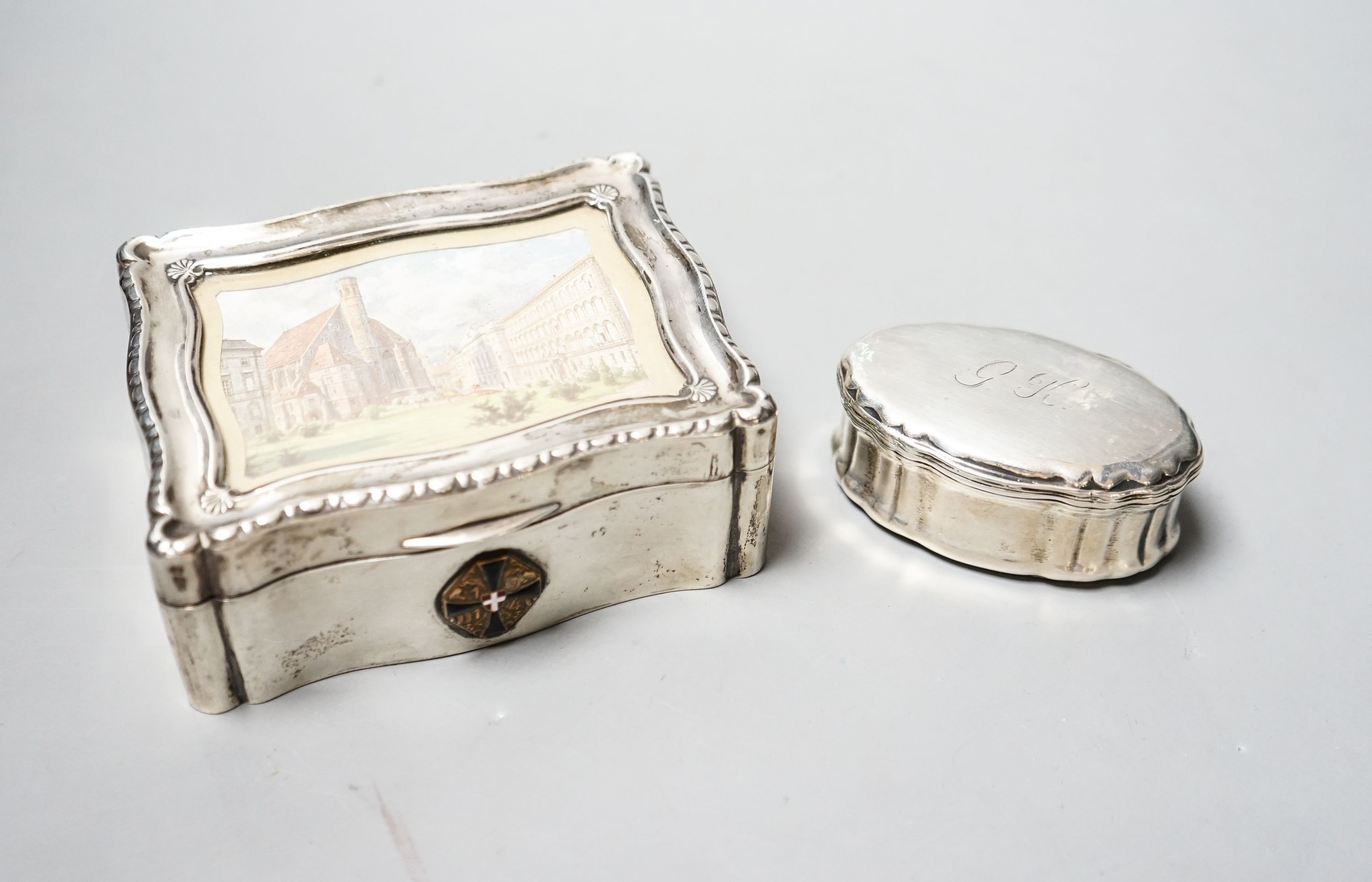 An Austro-Hungarian white metal mounted cigarette box with lid inset with print of a townscape, 12.3cm and a continental white metal oval snuff box.